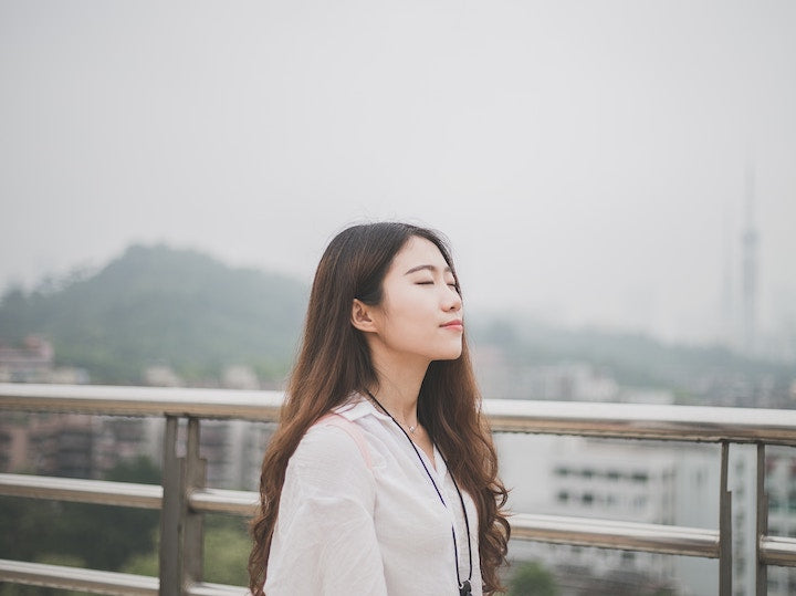 Woman relaxing next to steel railing