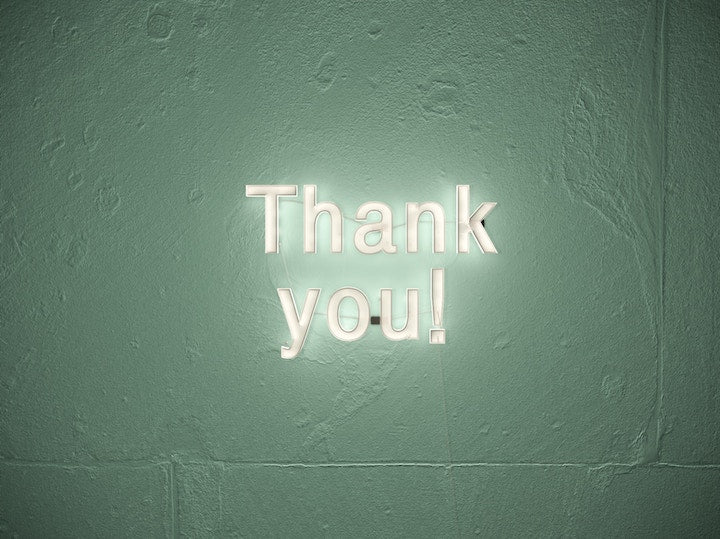 Thank you sign on wall with lights