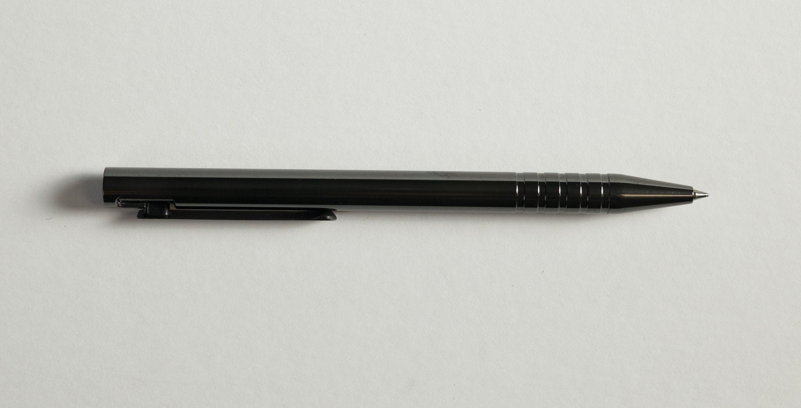 Polished Zirconium Adjustable Bolt Action Pen, full profile, flame-anodized obsidian black